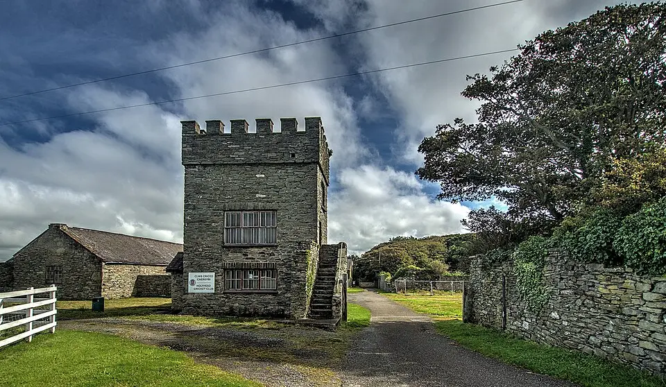 Baillifs Tower and with boundary wall, gates and attached outbuildings at Penrhos Home Farm